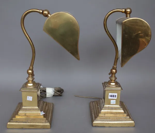 A pair of gilt metal Victorian style desk lamps, each with adjustable shade over a stepped square base, 43cm high. (2)