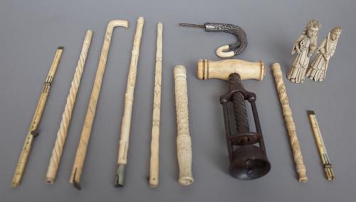 An early 19th century steel framed corkscrew with a turned bone handle, 18cm, several late 19th century ivory parts form parasol handles, two carved b
