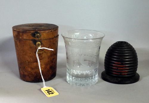 An early 19th century French glass tumbler, engraved with buildings and people and text "MCLG 18 Novembre 1809, 20 ans par amitie", in leather travell