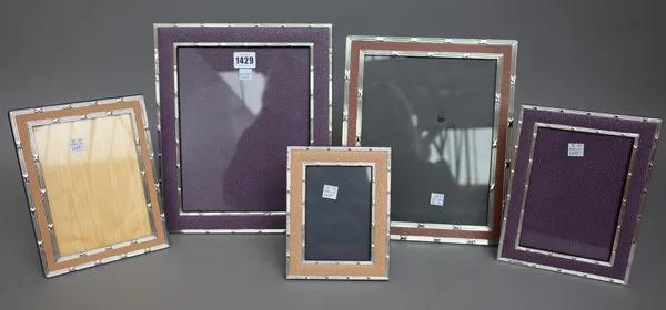 Eight modern silver plate mounted strut back photography frames, each with faux shagreen or faux leather wide borders, the largest 31cm high x 25.5cm