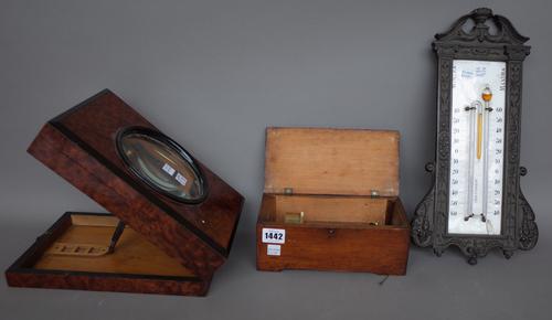 A Czechoslovakian cylinder music box of small proportions by F. Rzehitschek Prag, 21.5cm wide, a French metal and enamel wall thermometer, 38cm high a