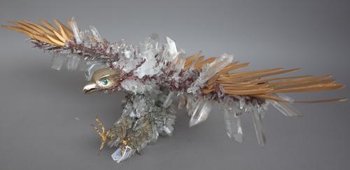 A rock crystal and gilt metal mounted eagle sculpture, raised on a lapis lazuli base, unsigned, wingspan 59cm wide. (a.f.)