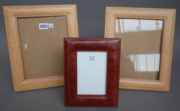 A pair of Thomas Goode leather bound strutback photograph frames, 31cm x 26cm, a smaller red leather version, a shagreen covered frame and a red faux