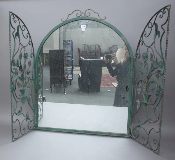 A modern green painted wrought iron wall mirror of domed form with triptych foliate cast doors, 90cm high.