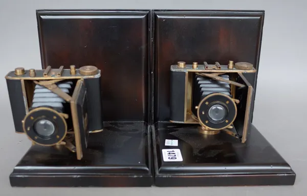 A pair of modern novelty hardwood bookends mounted with vintage style cameras, 19cm high, a small globe on glass stand, various coloured eggs, a shavi