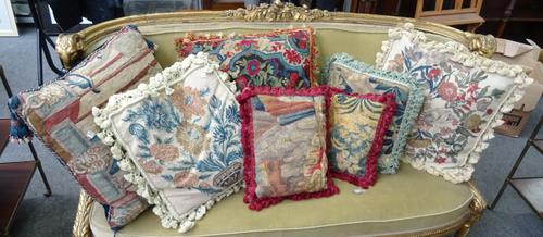 Thirty one woolwork embroidered cushions, mainly 20th century, foliate subjects. (31).