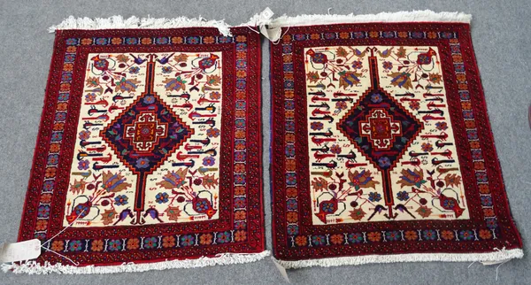 A pair of Baluchistan mats, the ivory field with indigo diamond, all with birds and flower motifs, 71cm x 80cm, (2).