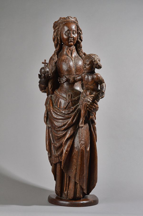 A 17th century carved oak figure group of a Madonna and child, 84cm high. Illustrated