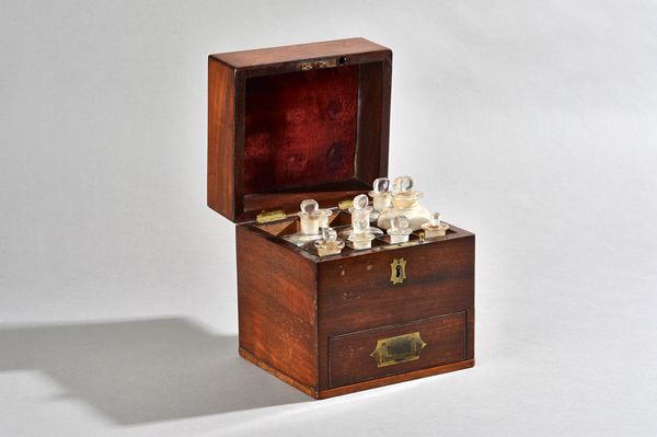 An early 19th century mahogany apothecary box, with fitted glass bottle interior, over single drawer, 17cm wide x 19cm high.