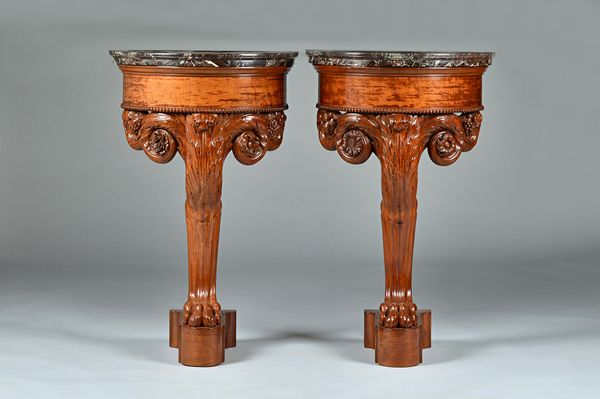 A pair of Louis Philippe mahogany consoles by Jacob-Desmalter, each with semi-elliptic marble top on acanthus headed lions leg monopodium, 64cm wide x
