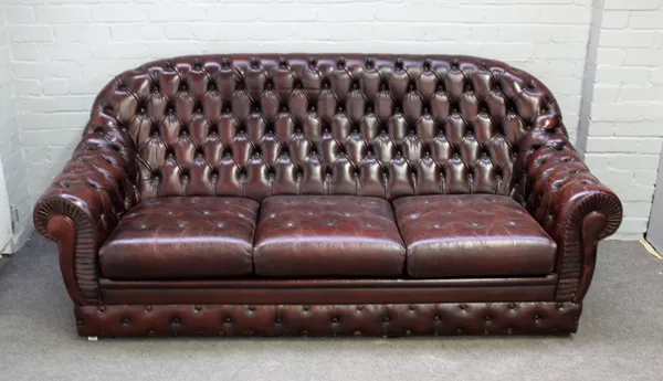 A 20th century tan leather button back sofa with downswept arms, 195cm wide x 88cm high.