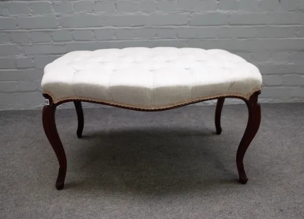 A 19th century mahogany framed footstool of serpentine outline on cabriole supports, 83cm wide x 47cm high.