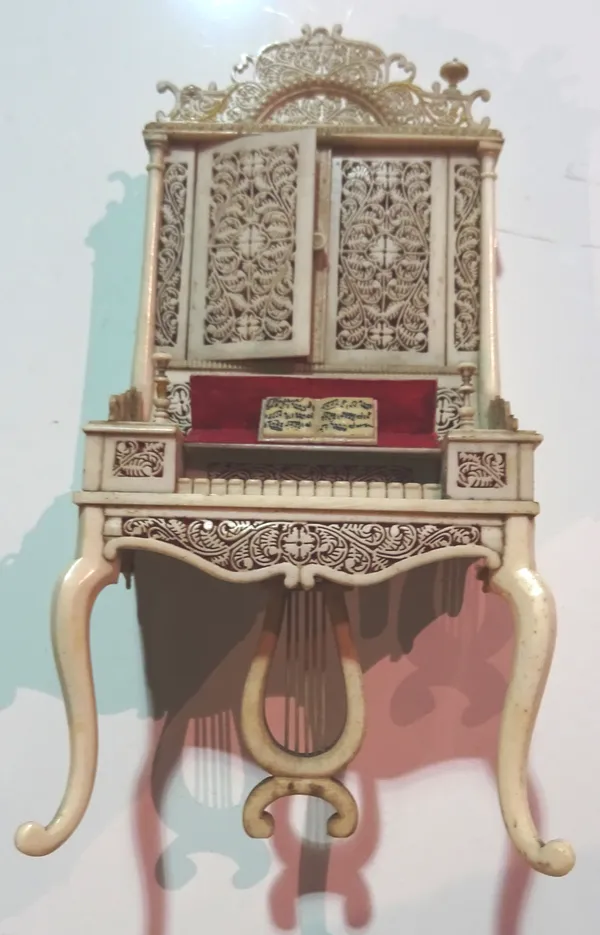 A late 18th / early 19th century miniature ivory model of a piano with over cabinet.