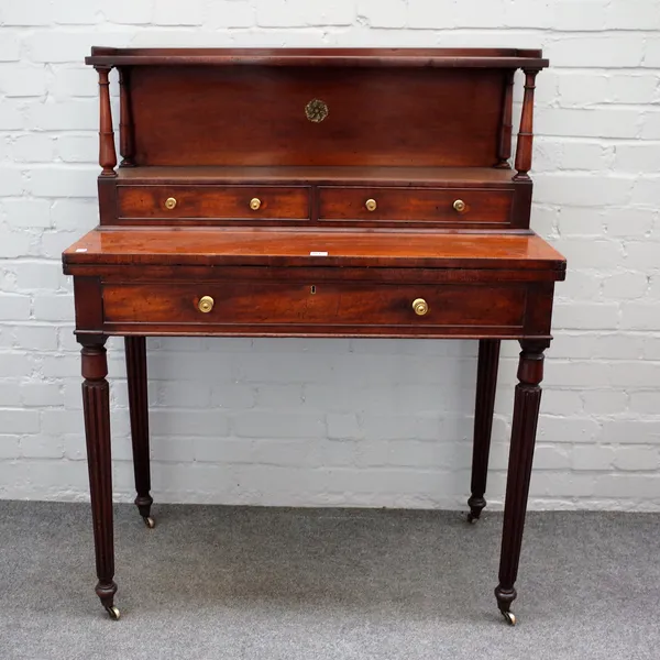 A William IV mahogany writing desk with two drawer ledge back over single drawer on reeded supports, 93cm wide x 118cm high.