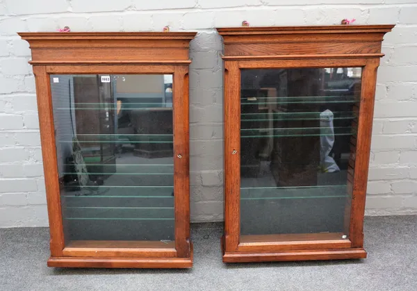 A pair of 20th century oak glazed single door hanging display cabinets, 63cm wide x 92cm high, (2).