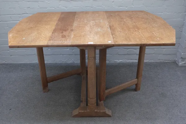 Heals; a limed oak drop flap table, on canted square supports, 91cm wide x 137cm long open.