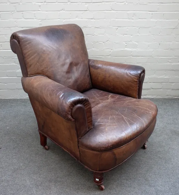A 19th century brown leather upholstered easy armchair, on turned supports, 90cm wide x 91cm high,