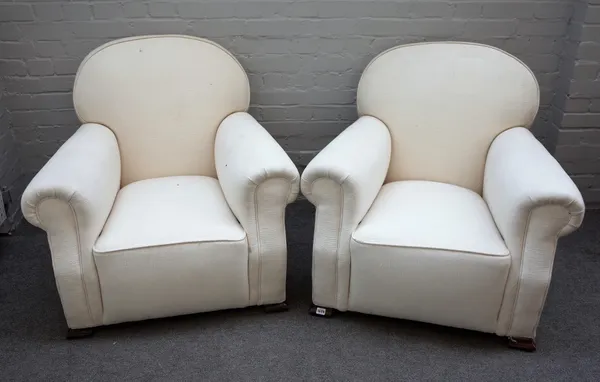 A pair of early 20th century easy armchairs with rollover arms on splayed block feet, 87cm wide x 85cm high.