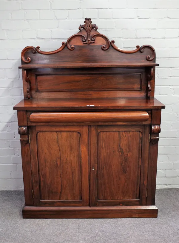 A Victorian rosewood ledge back chiffonier with cushion drawer over cupboards, 107cm wide x 154cm high.