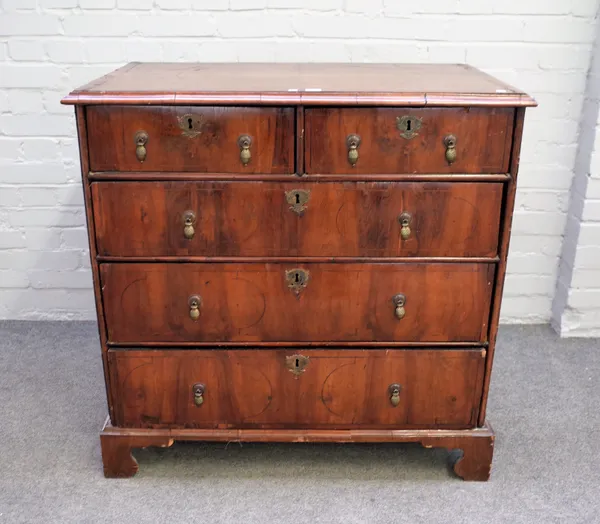 An early 18th century figured walnut chest with two short over three long graduated drawers on bracket feet, 96cm wide x 94cm high.