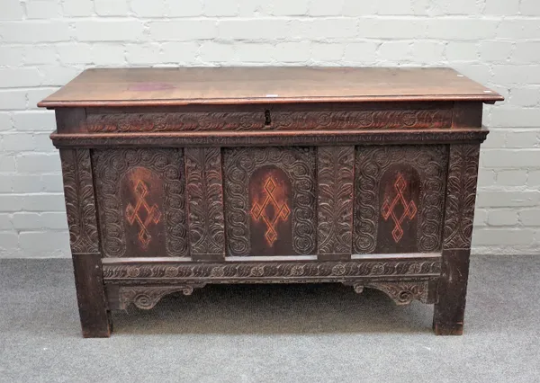 A 17th century French oak coffer with twin plank top over carved and inlaid triple panel front, 128cm wide x 75cm high.