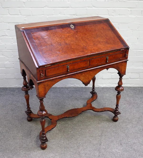 A 17th style mahogany banded figured walnut bureau with pair of short drawers on turned supports united by shaped 'X' frame stretcher, 80cm wide x 94c