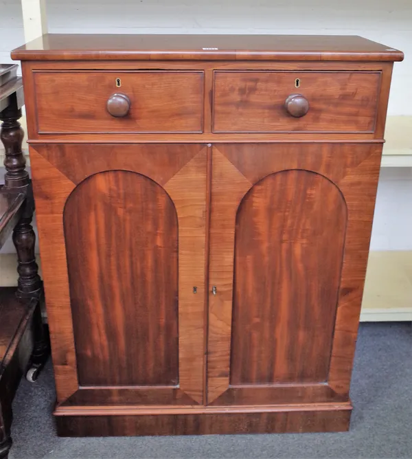 A Victorian mahogany side cabinet with pair of drawers over arched panel cupboards, 83cm wide x 108cm high.