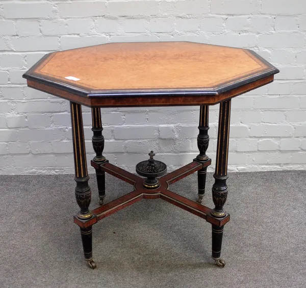 An Aesthetic Movement amboyna and ebonised octagonal centre table, on fluted supports, 84cm diameter x 73cm high.