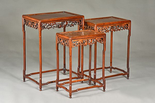 A nest of three Chinese 19th century hardwood occasional tables, with floral carved frieze, the larger 52cm wide x 72cm high.