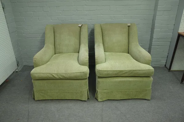 A pair of green upholstered easy armchairs with downswept arms on tapering block supports, 75cm wide x 85cm high.