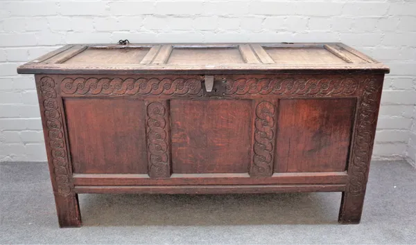 A 17th century oak coffer with triple panel lid and front, 136cm wide x 70cm high.