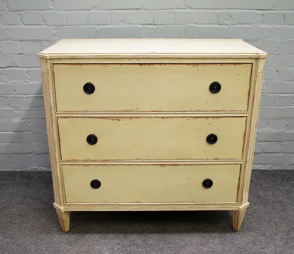 An early 20th century continental cream painted three drawer commode on tapering channelled square supports, 90cm wide x 86cm high.