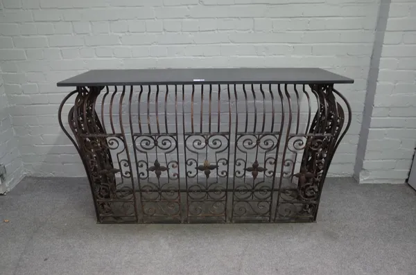 A French console table, the rectangular slate top over a bombe wrought iron base, 147cm wide x 85cm high.