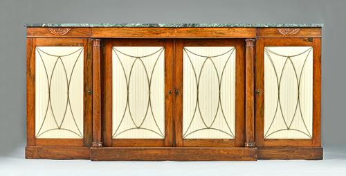An early Victorian breakfront side cabinet, the marble top over a rosewood four door base divided by turned columns, 207cm wide x 94cm high. Illustrat