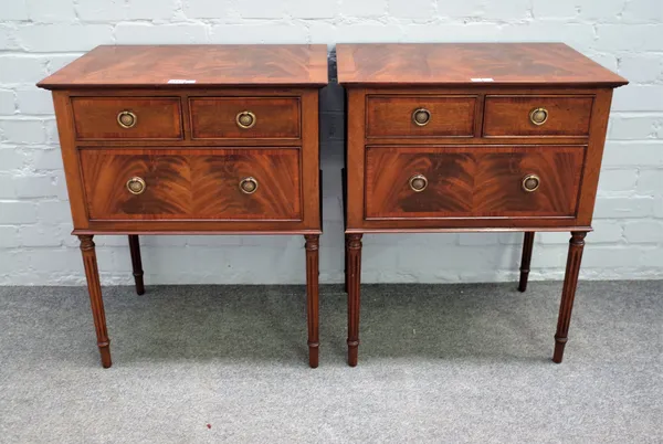 A pair of 20th century mahogany bedside tables each with two short and one long drawer on fluted supports, 93cm wide x 73cm high.