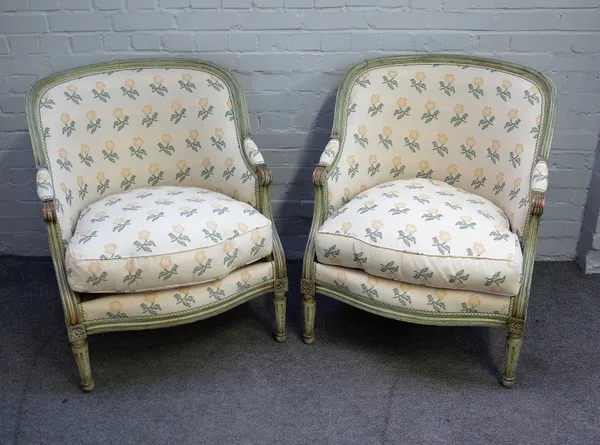 A pair of Louis XV/XVI transitional style tub back armchairs with green painted frames on tapering fluted supports, 73cm wide x 90cm high.