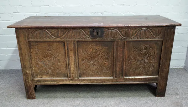 A 17th century and later oak coffer, with carved triple panel front, 131cm wide x 65cm high.