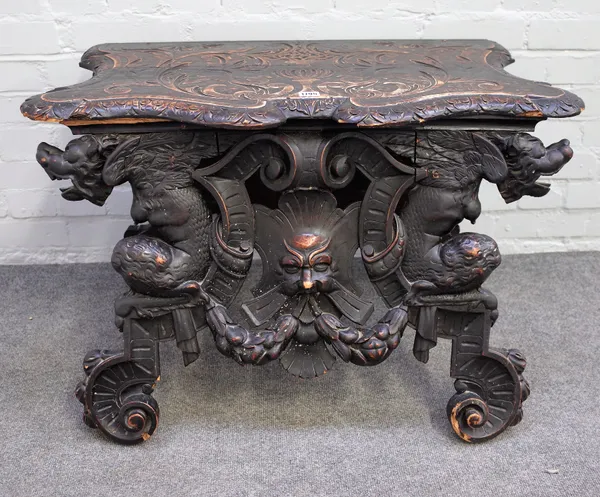A 19th century Italian carved oak side table, the frieze carved with green man flanked by winged beasts, 86cm wide x 55cm high.