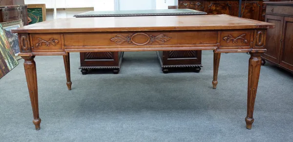 A 19th century French walnut bureau plat with carved frieze on tapering fluted supports,170cm wide x 100cm deep.