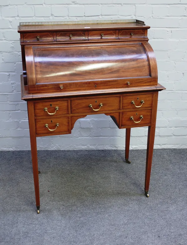 A late 19th century inlaid mahogany cylinder bureau with five frieze drawers on tapering square supports, 78cm wide x 106cm high.
