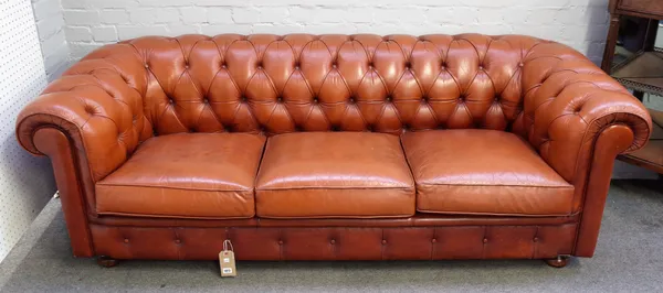 A brown leather buttonback Chesterfield sofa on bun feet, 215cm wide x 70cm high.