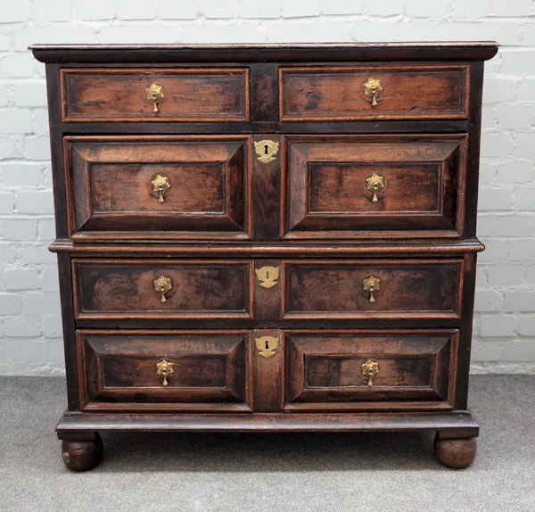 A late 17th century oak chest with two short and three long geometric moulded drawers on bun feet, 99cm wide x 98cm high.
