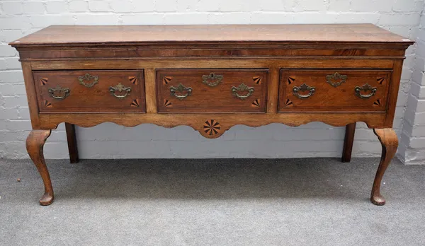 A mid-18th century inlaid oak three drawer dresser base on cabriole supports, 178cm wide x 84cm high.
