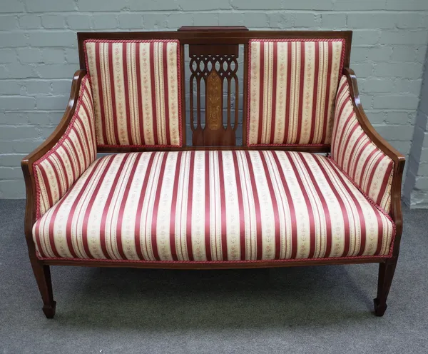 An Edwardian marquetry inlaid mahogany square back three piece suite comprising sofa, 121cm wide x 94cm high, and a pair of matching armchairs, 62cm w