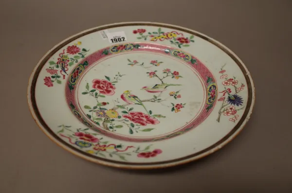 A Chinese famille-rose plate, early Qianlong, painted in the centre with two birds amongst flowering branches, 29cm. diameter.