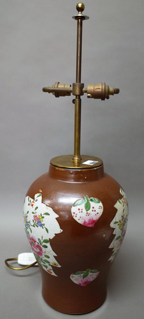 A Chinese Batavian ware baluster vase, late 18th century, painted with three large leaf shaped panels enclosing flowering branches, divided by pairs o
