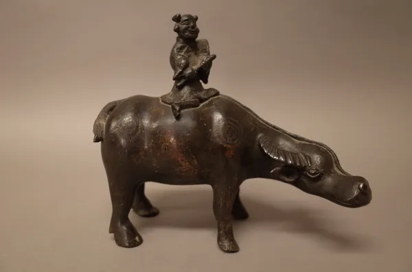 A Chinese bronze group of a boy on a buffalo, possibly 17th century, 20cm. high.