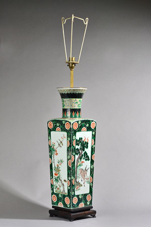 A Chinese famille-noire vase, 19th century, of tapered square section, one side painted with a panel of a deer beneath a pine tree, another side paint