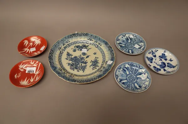 A pair of Chinese coral-ground saucers, possibly Daoguang, each decorated with bamboo and a bat, iron red seal marking reading, Made for the master of
