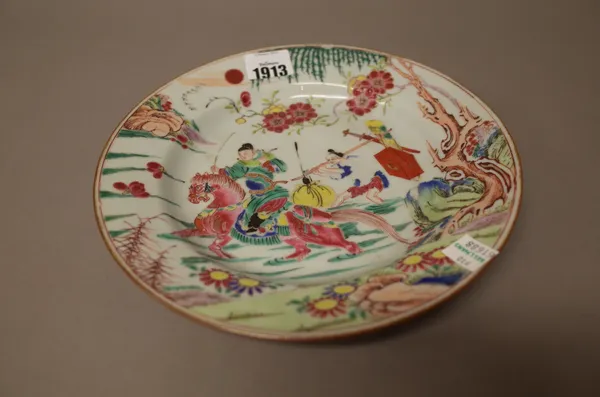 A Chinese famille-rose plate, Yongzheng/early Qianlong, painted with a figure on horseback with an attendant walking behind, ( a.f), 22.5cm. diameter.